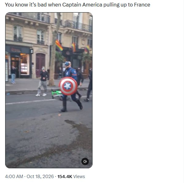 Captain America cosplayer with a shield on a Paris street during protests